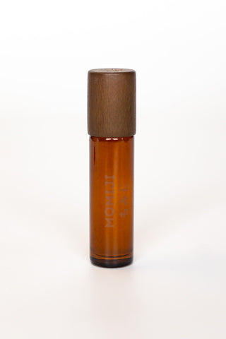 Brown roller skin scent bottle with wooden cap on a white background