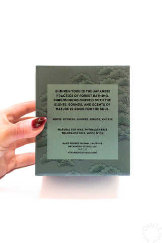 Hand holding a green box with text about Shinrin-yoku