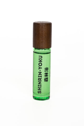 Green rollerball bottle with wooden cap on a white background
