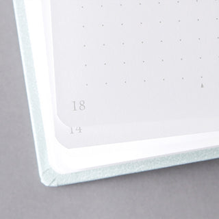 Dot grid page corner with rounded edge and printed page numbers