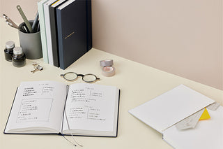 Open A5 hard cover dot grid notebook with white pages and visible spine