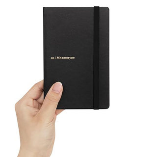 Black hard cover notebook with elastic band, “Mnemosyne” label on cover