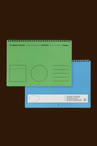 Green and blue planners on a black background