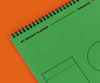 Green planner with 'My Project Planner' text on an orange background