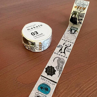Washi tape with cat-themed design on a wooden surface