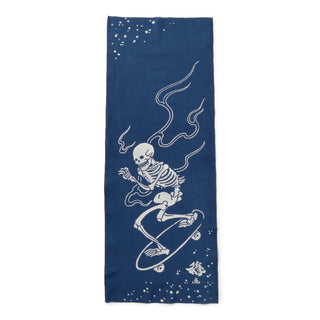 Navy blue towel with a white skeleton on a skateboard design