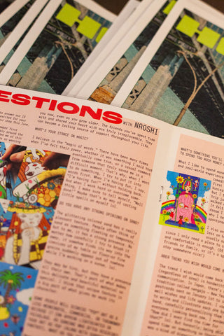 Open magazine pages with dense text and colorful illustrations