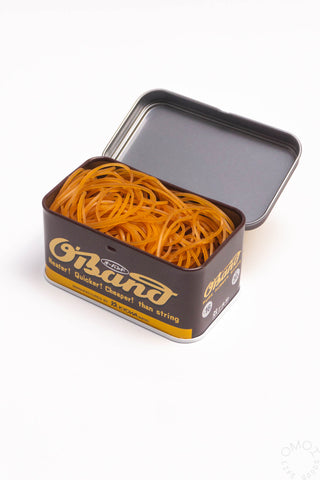 Natural rubber band tin open, orange bands inside metal storage case.