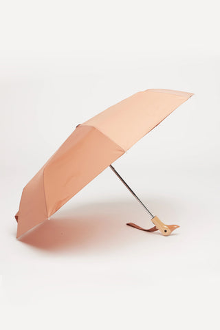 Opened mocha color umbrella with wooden duck head handle