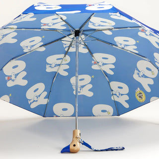 Blue umbrella with white Yo text with Snoopy pattern and a wooden duck shaped handle on a white background