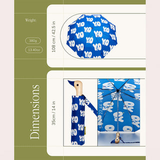 Blue umbrella with white Snoopoy patterns on a green background