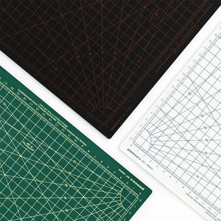 Three cutting mats with grid lines and measurements on a white background