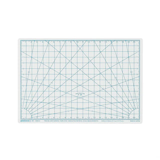 A cutting mat with a white grid and blue measurement lines