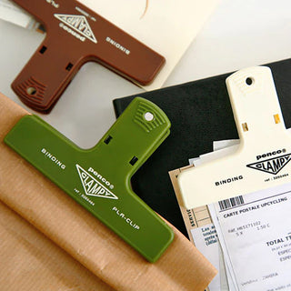 Close up of penco binder clips holding various paper objects