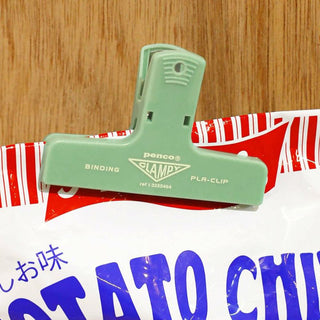 A mint penco binder clip holding a bag of chips
