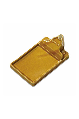 Brown ceramic incense holder tray on a light background