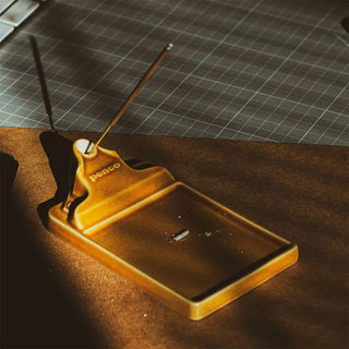 ceramic incense holder with 'Penco' branding on a dark surface