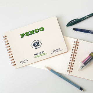 Penco sketchbook with pens on a white surface