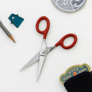 Small stainless steel scissors with red plastic handles