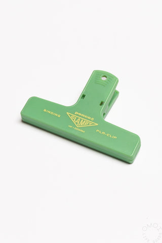 A mint colored penco binder clip on a white background