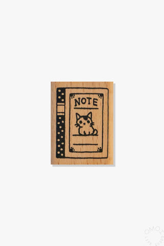 Wooden block with a design of a notebook and a cat on a white background