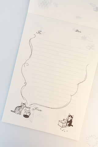 Memo pad page with illustration of a cat grinding coffee and another cat smelling coffee