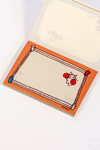 Notepad with a cartoon cat design on an orange border
