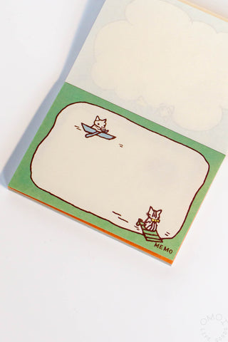 Memo pad with cat illustrations on a white background