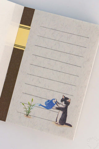 Notebook page with a cat watering plant illustration