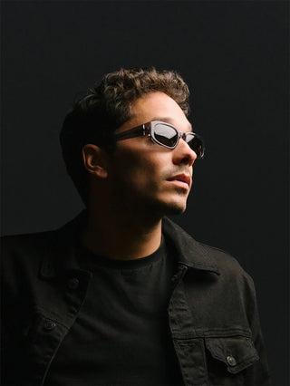 Black sunglasses with reflective silver temples and dark lenses on a man