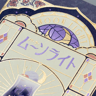 Decorative post card with 'MOON LIGHT' text and Japanese characters on a blue and gold background.