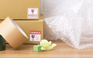SMISKI moving glow mini figurine on a small display base, green