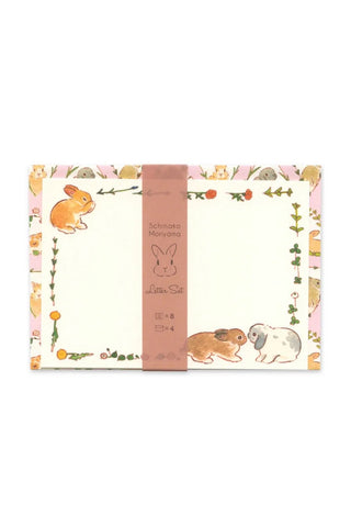 Product packaging with cartoon rabbits and decorative border on a white background