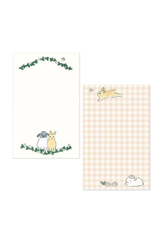 Two sheets of paper with cartoon animal illustrations on a white background