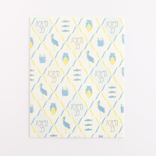 Patterned paper with blue and yellow shoebill designs on a white background