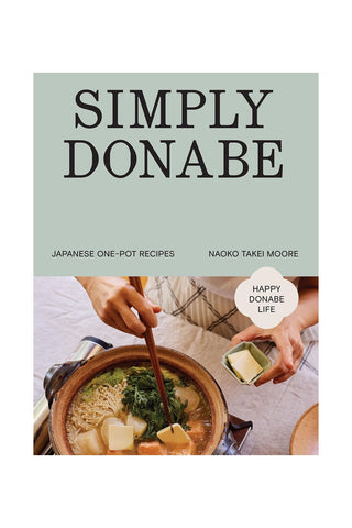 Book cover of 'Simply Donabe' with a person putting food in a pot
