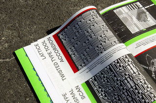 Open magazine with text and design on a textured surface