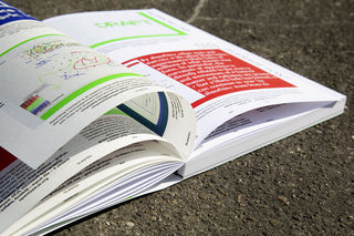Open magazine with colorful text and diagrams on a textured surface
