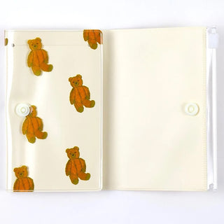 Small 5-pocket pouch open flat, teddy-bear print on left, clear pockets and snap