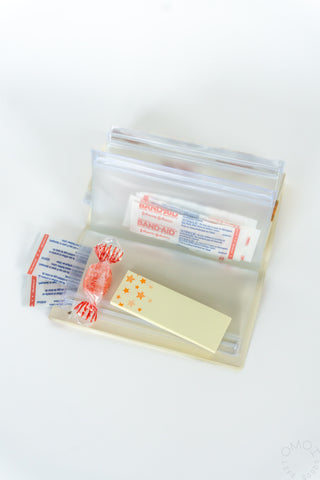 Small 5-pocket pouch with clear pockets holding small packaged items
