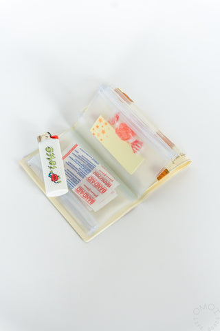 Small 5-pocket pouch with clear pockets holding colorful packaged stationery