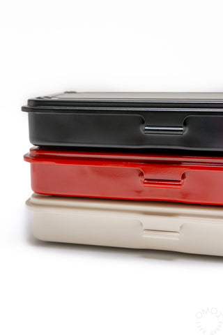 Stacked toolboxes: black lid on red base with side handle cutout