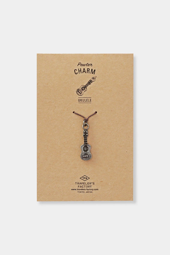Pewter ukulele charm on kraft display card with brand text
