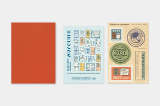 Orange passport monthly planner cover with 2027 Traveler's Company design