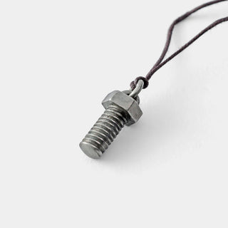 Metal screw pendant on a thin string against a light gray background