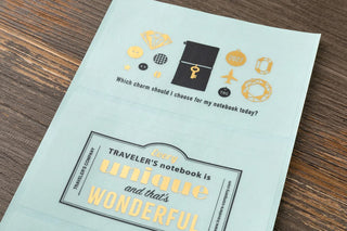 Light blue sticker sheet with small icons and travel-themed phrases