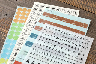 Sheet of date and alphabet stickers with number circles and grid labels