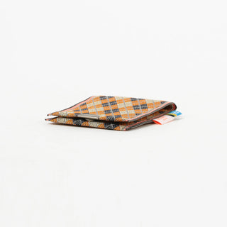 Argyle patterned coin purse flat lay on a white background