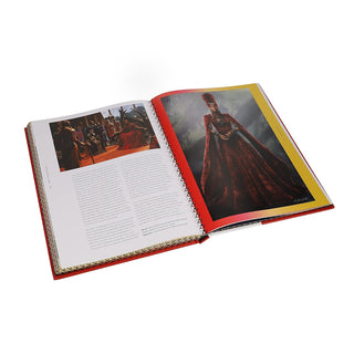 Open book with image of costume design and text on a white background