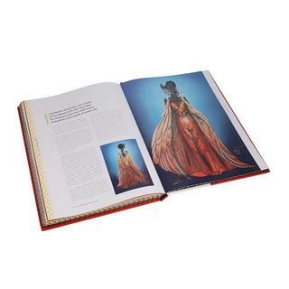 Open book with illustrations of a red dress on a white background
